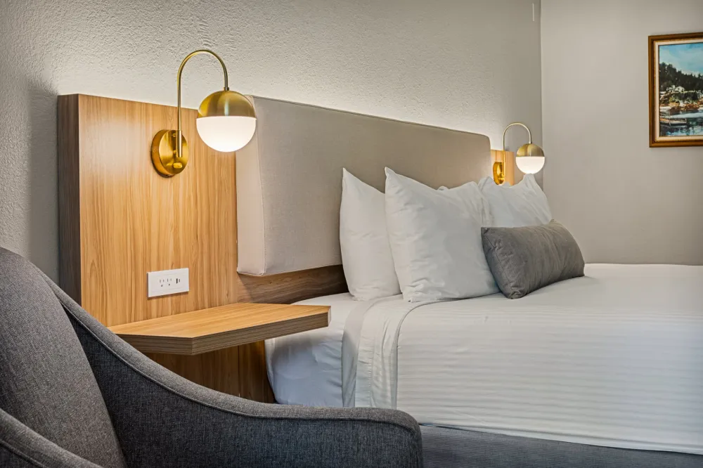 King room at Chateau Big Bear with brass reading lamps and a wood headboard